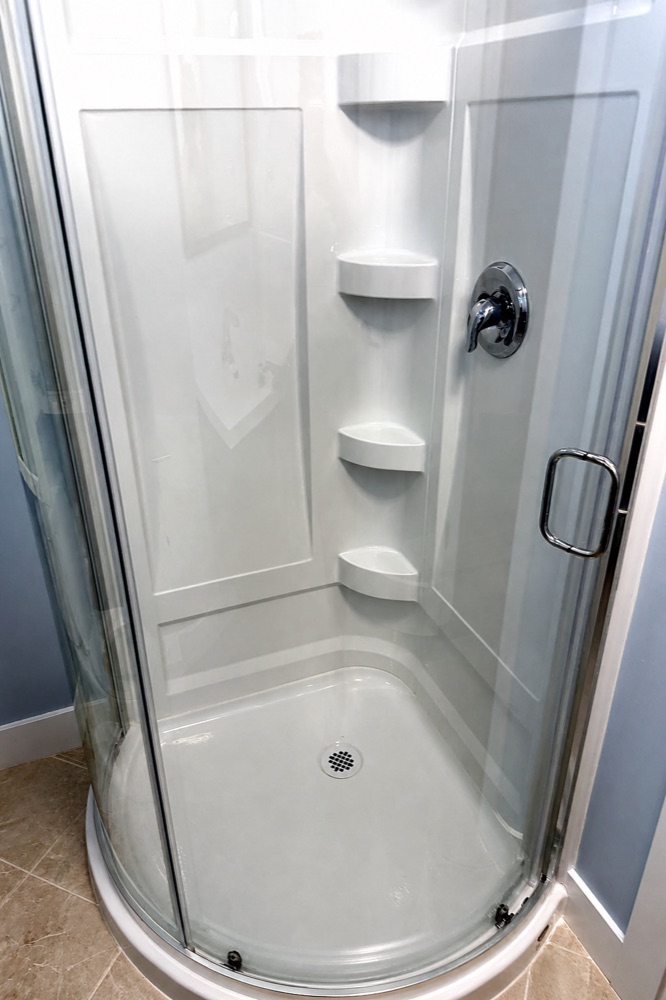Finished corner shower stall after a NeatNow clean in Calgary