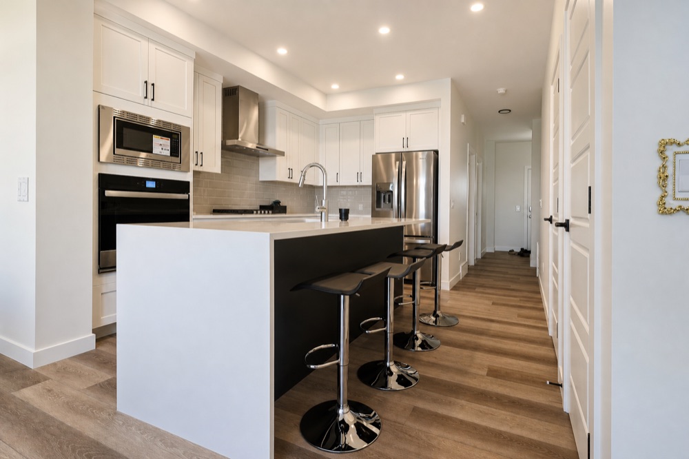 Finished kitchen with island and stainless appliances after a NeatNow clean in Calgary